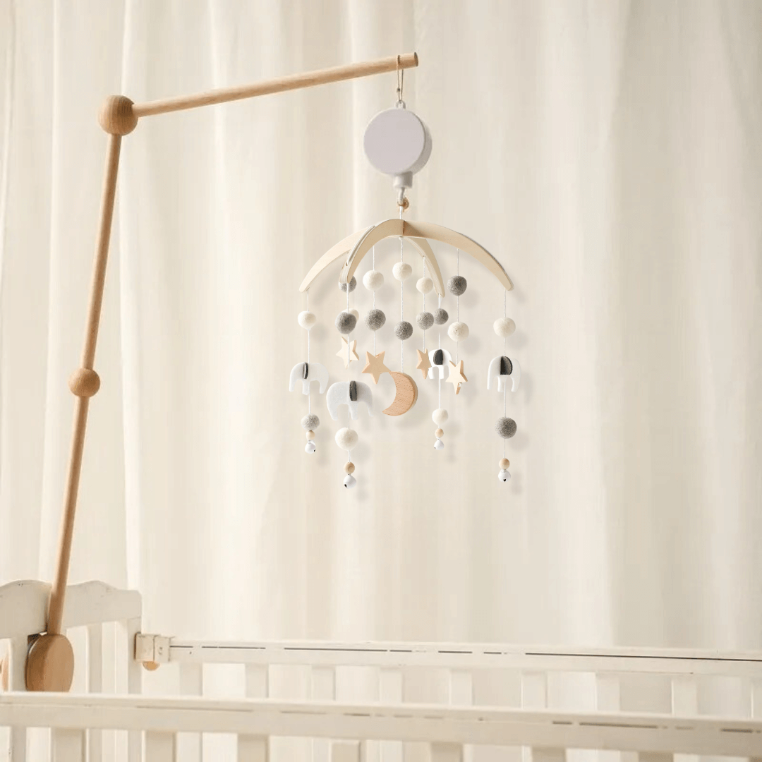 mobile musical lit bébé avec une lune en bois et des billes en feutre grises et blanches